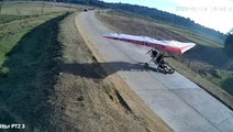 Paragliders crash land on road sending car swerving