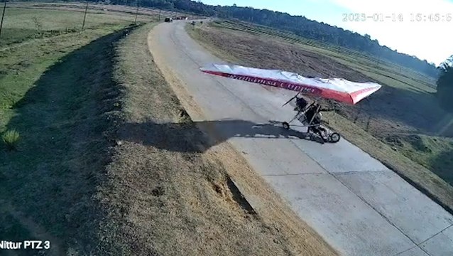 Paragliders crash land on road sending car swerving