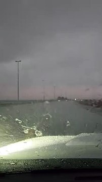 Car drives through rain on waterlogged roads in Sharjah