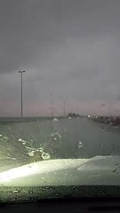 Car drives through rain on waterlogged roads in Sharjah