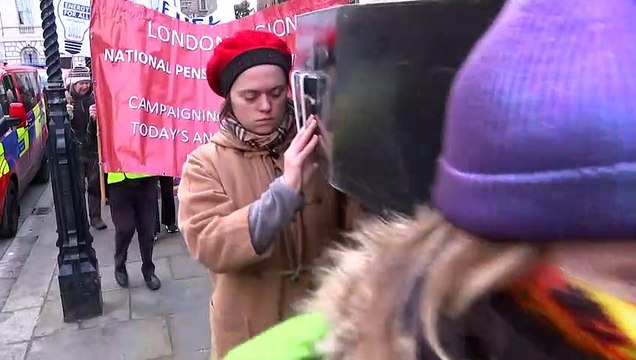 Mock coffin carried to protest excess cold-related deaths