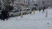 Snow Covered Slippery Road Causes Oncoming Car to Crash Into Parked Vehicles