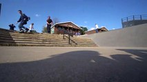 Inline skater attempts backflip from stairs at skatepark and lands on back
