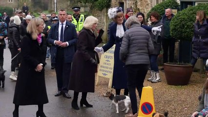 Small dog delights Camilla before tree-planting at Church