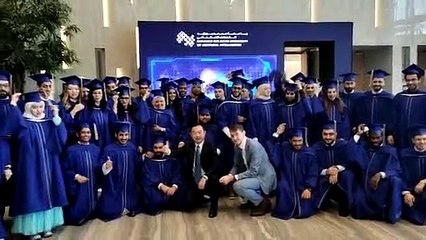 MBZUAI graduates throw their hats into the air in celebration