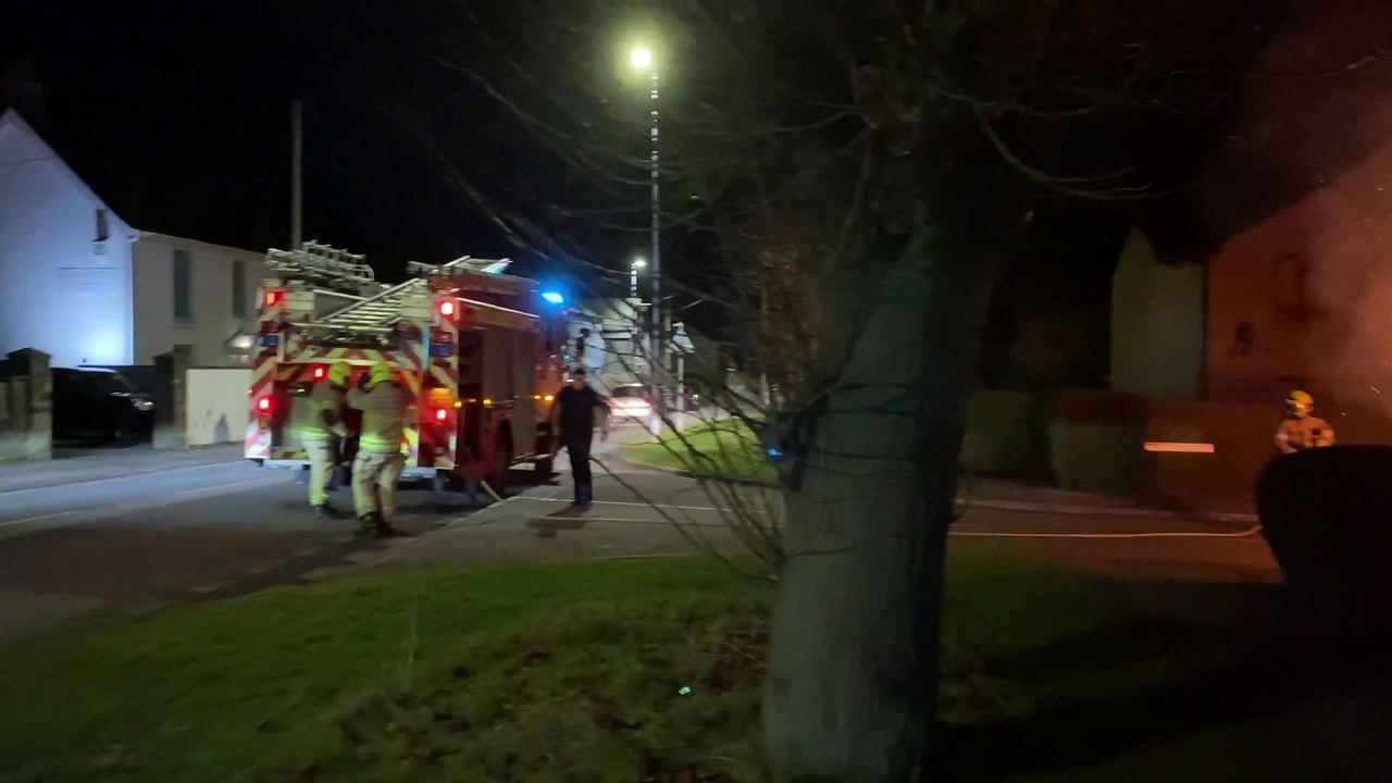 The fire service extinguishing a hedge fire in Abergavenny