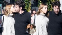 Casey Affleck locks lips with girlfriend Caylee Cowan as pair wrap their arms around each other.
