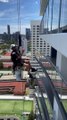 Window Cleaner Stops to Pet Dog on High Rise Building