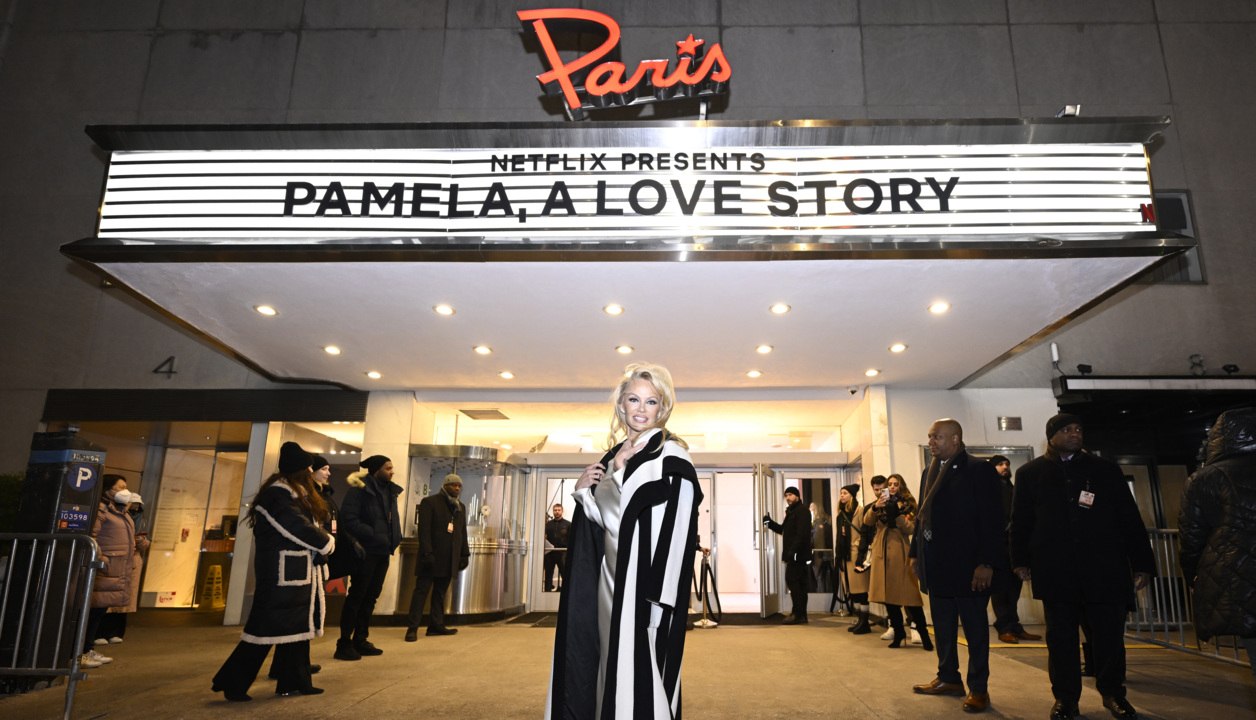 Pamela Anderson Paired a Cowl Neck Satin Gown with a Draped Wool Coat