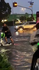 Guys Ride Through Flooded Streets on Electric Scooters