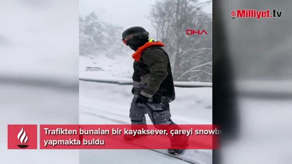 Trafiğe takılmamak için snowboard yaptı