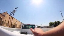 Skateboarder hitches ride on back of pickup truck and gets hit by car