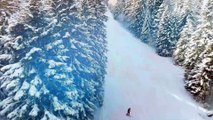 Aerial footage of skiers skiing down the mountain (4K Video Ultra HD)