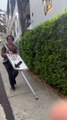 Man Carries Around Street Sign