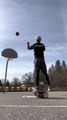 Guy Perform Simultaneous Basketball Shots While Balancing Himself on Balance Board