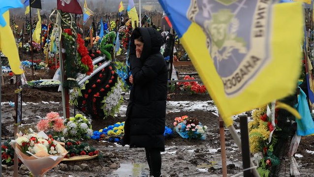 Ukrainian flags fly over soldiers’ graves at military cemetery