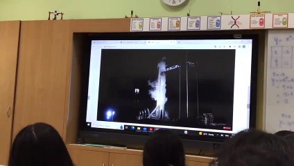 Watching  the liftoff from a classroom