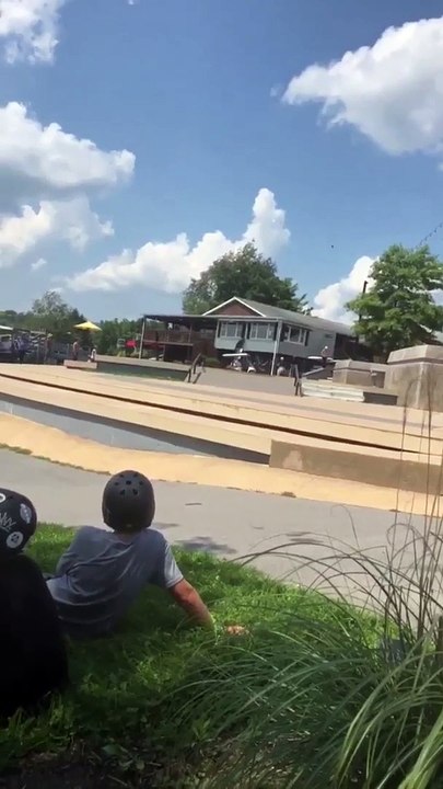 Scooter kid jumps ledge at Woodward skate camp
