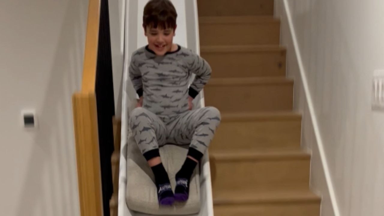 *DIY slide idea* Kids enjoying their makeshift stair slide with delight