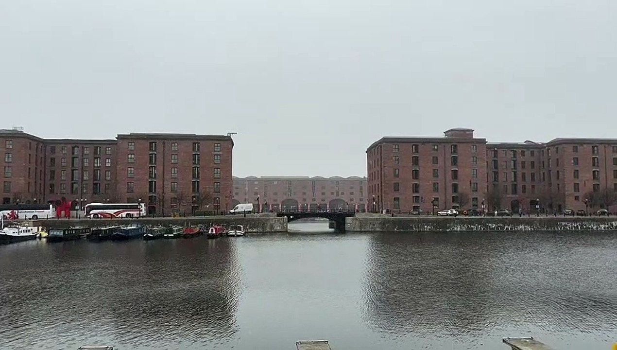 Footage shows man casually rowing on the Albert Dock as snow blizzard hits Liverpool