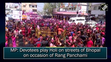 Devotees play Holi on streets of Bhopal on occasion of Rang Panchami