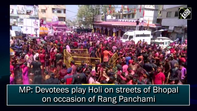 Devotees play Holi on streets of Bhopal on occasion of Rang Panchami