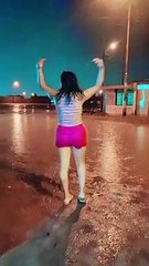 Mujer zapatea bajo la lluvia al ritmo de huayno.