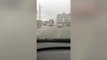 A water spout reaching 30 ft has nearly halted traffic as it sprayed across a busy road in south-east London