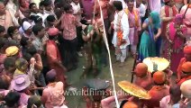 A rare holi sight! Women beating the men...