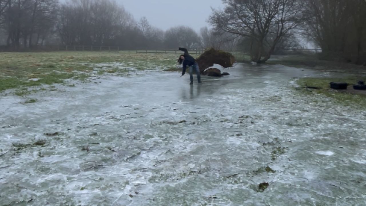 Girl HILARIOUSLY slips and falls while walking over frozen lake
