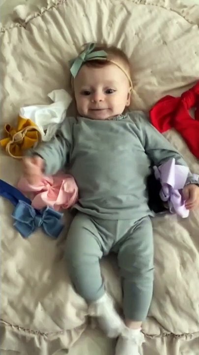 Adorable baby girl shows off her bow collection