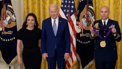 Joe Biden holds hands with Julia Louis-Dreyfus as he presents her National Medal of Arts