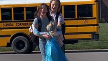 Adorable girl takes a break from her playtime to welcome big sisters back from school
