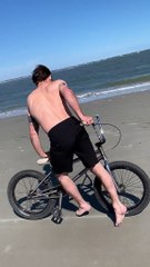 Cyclist Moonwalks on the Beach