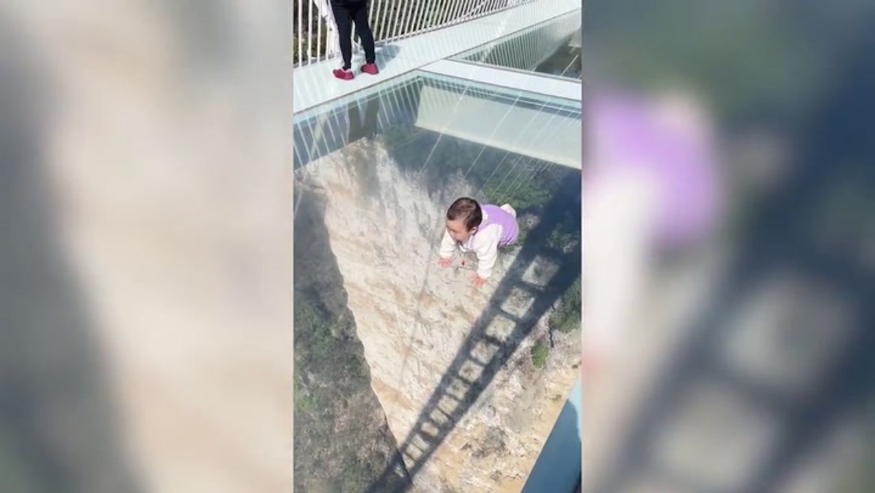 Fearless baby crawls over glass bridge with 1,000ft drop