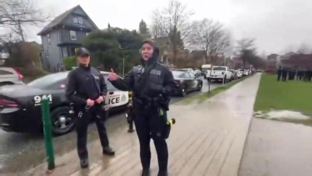Vancouver female Police officer laughed who cowers away when a mob of trans activists get violent? police hired some liberal officers, who when challenged, run faster than Bill Clinton pulling down his pants in an Arkansas trailer park