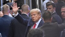 Donald Trump waves as he arrives at court for historic arraignment
