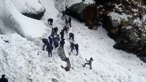Army personnel clear snow after avalanche sweeps away group of tourists in the Himalayas