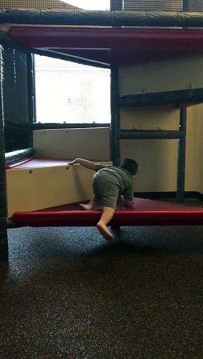 Funny baby head down on slide