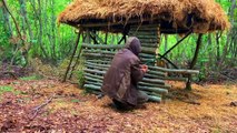 Building complete and warm survival shelter Bushcraft log cabin, grass roof & fireplace with clay.