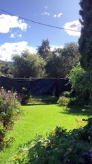 Winds blowing a tarp with asbestos underneath at Cotterill Ave, Woonona on Saturday, March 8. Video supplied.