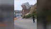 Moment building collapses onto road after landslide in Mexico