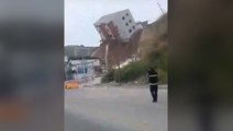 Moment building collapses onto road after landslide in Mexico