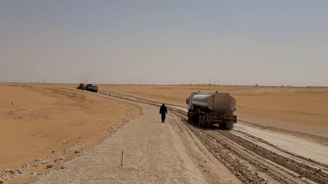 Desert work water tanker spraying water.