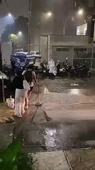 Woman Trips on Curb in Heavy Rain
