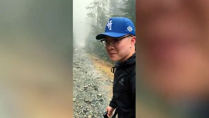 Huge black bear stalks group of friends along hiking trail
