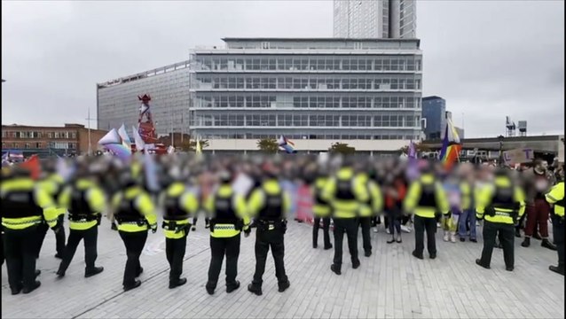 Police form barrier between protesters from both sides of transgender debate in Belfast
