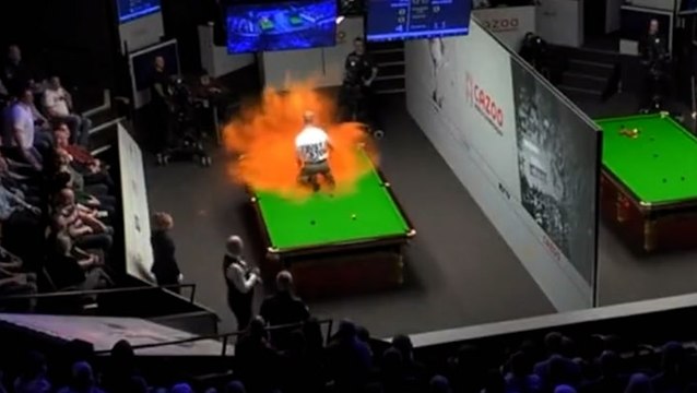 Protester interrupts World Snooker Championship and covers table with orange powder