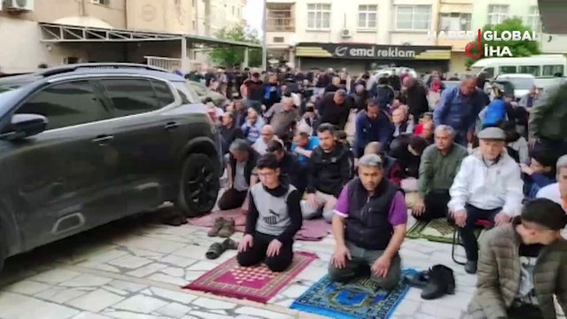 Bayram namazını yıkılması için boşaltılan orta hasarlı binanın altında kıldılar