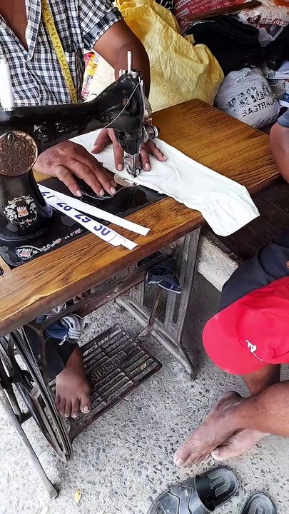 Young Indian men tailor working at home  . Tailor men sewing shirt collar